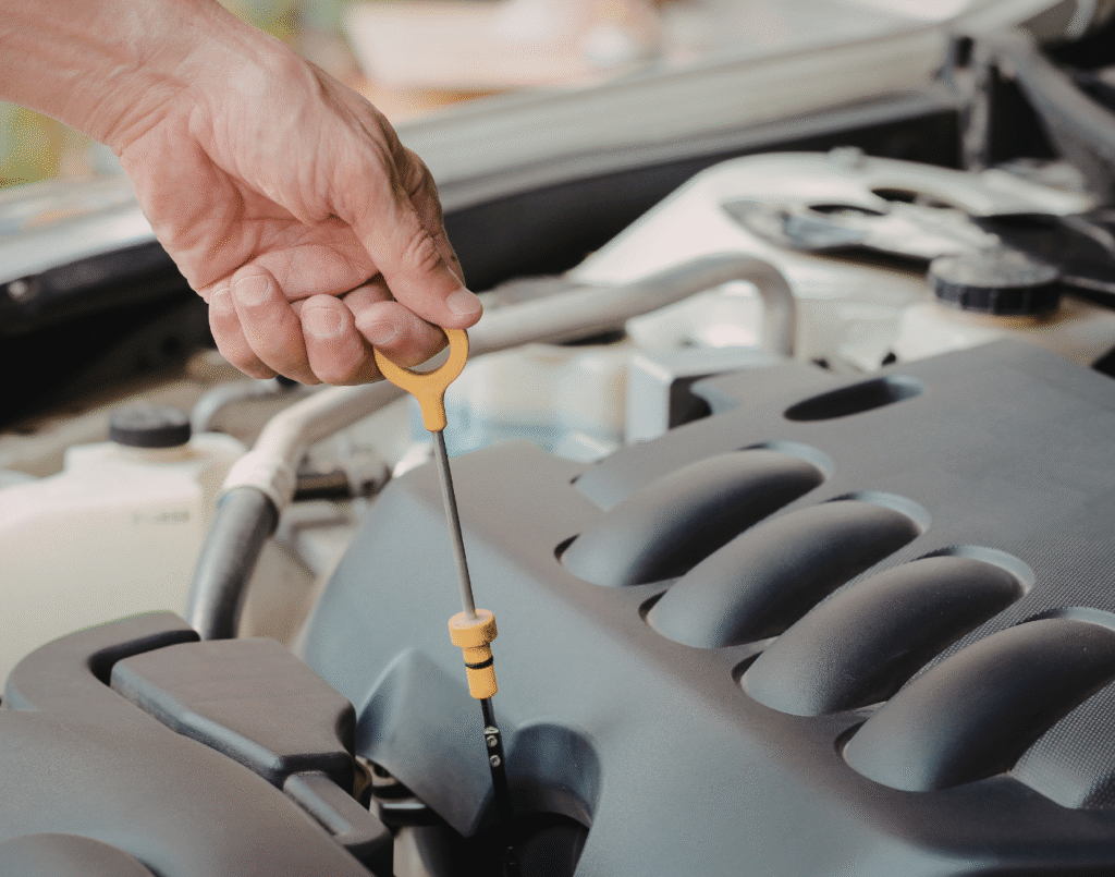 Vehicle owner checking the oil of their vehicle